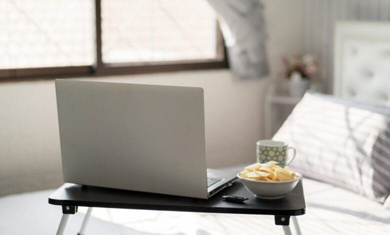 work-home-bed-table-laptop_istock